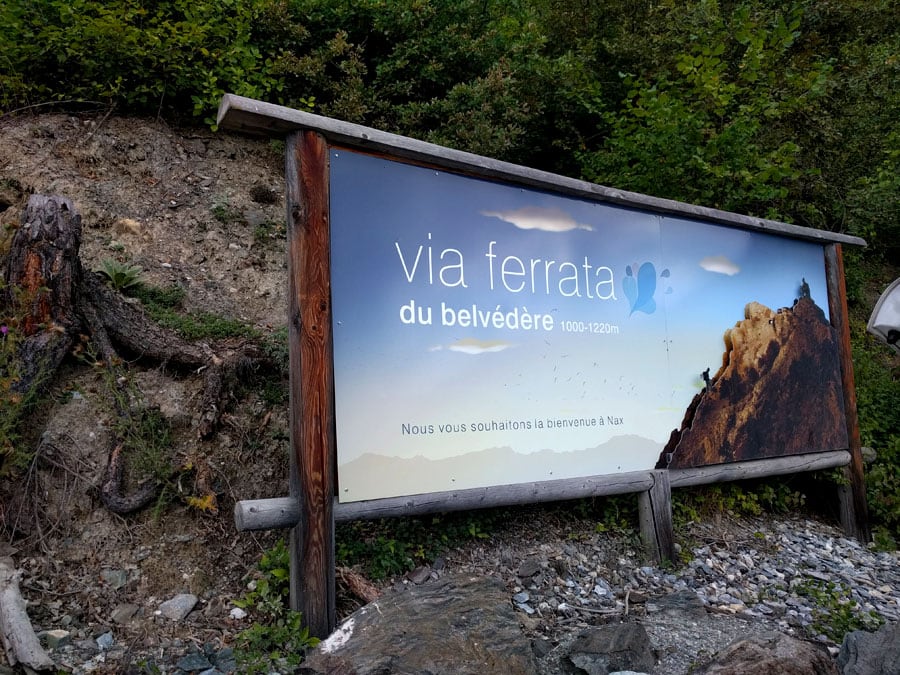 Signpost of the via ferrata visible from the road 