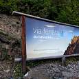Signpost of the via ferrata visible from the road 