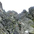 A 9-year-old boy climbs with his father 
