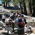 An armed park ranger validates the access permits with his iPad 